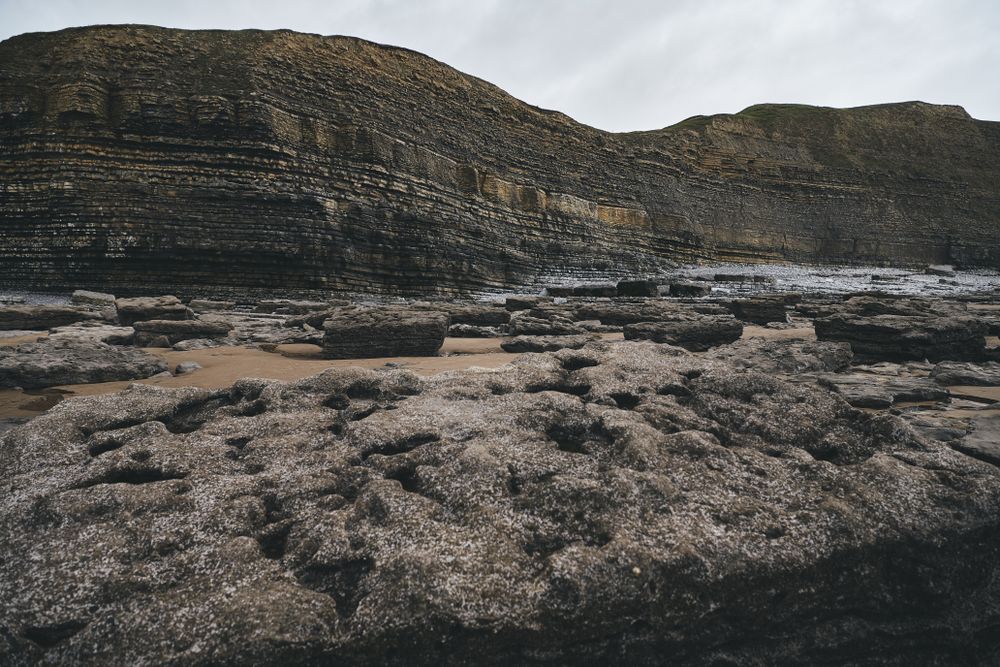 A river surrounded by rock face and sand