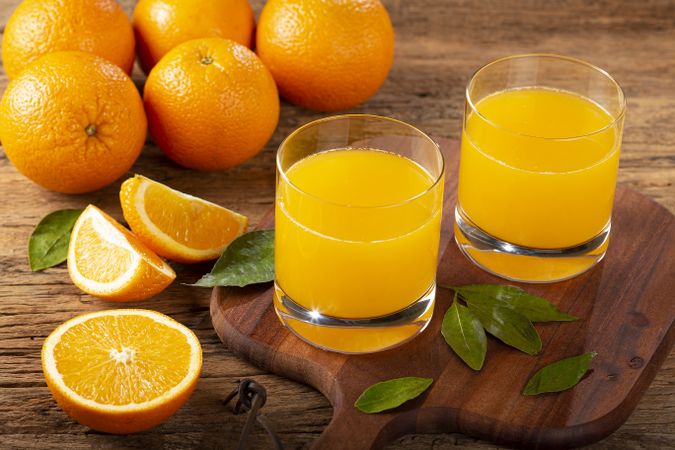 Glass with orange juice on the table.