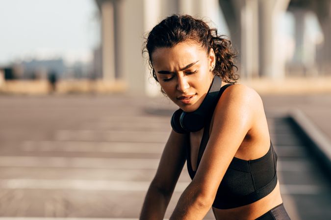 Serious woman in athletic gear outside