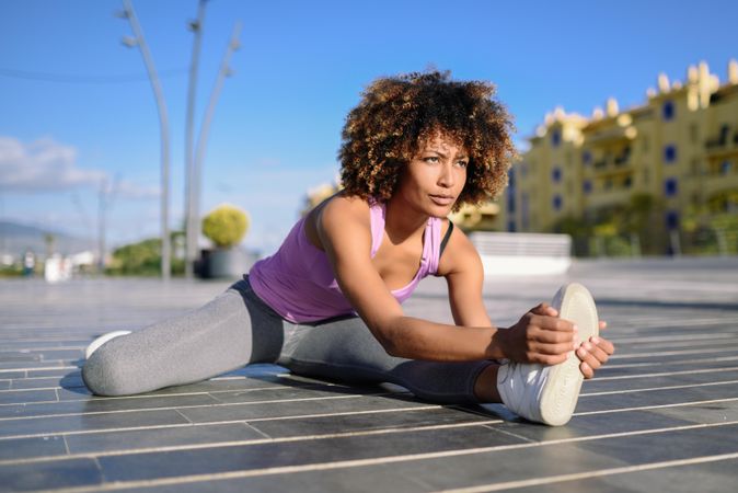 Female with afro cooling down with cityscape in the background