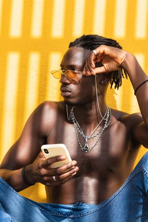 Black hipster guy using smartphone