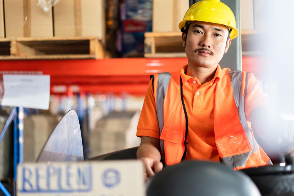 Man operating machinery in distribution center