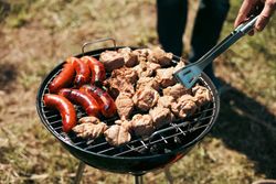 Meat is fried on a campfire, barbecue in nature. Pickled meat is cooked on coals, Grilled BBQ.