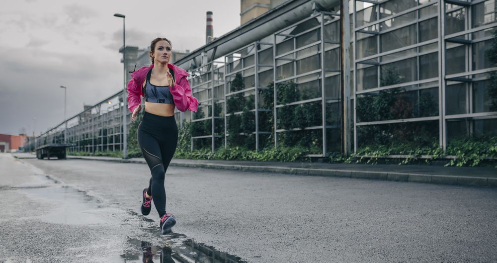 Sportswoman running in an industrial zone