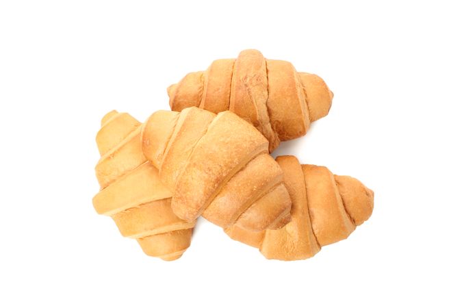 Top view of stacked croissants isolated on plain background