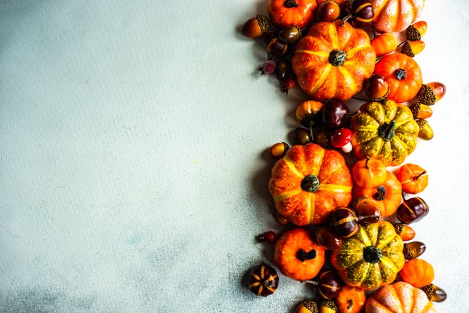 Top view of autumn flatlay with pumpkin ornaments and space for text