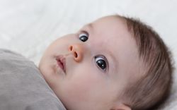 Happy baby girl lying on back