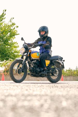 Biker riding motorcycle on asphalt road on motordrome