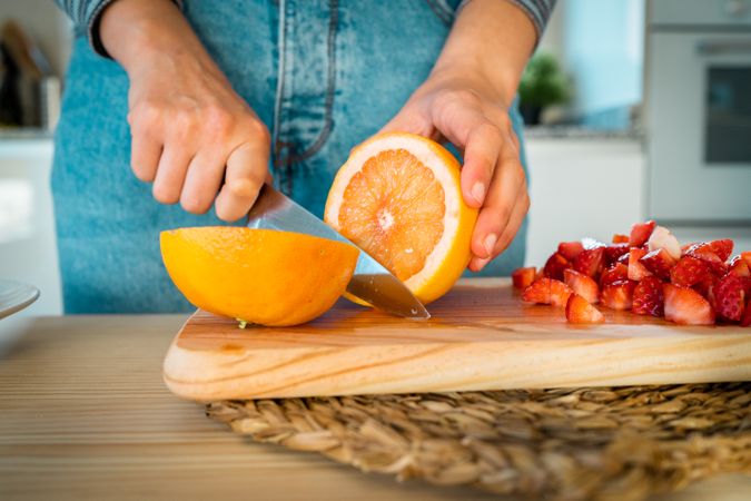 Woman cutting fruits in kitchen