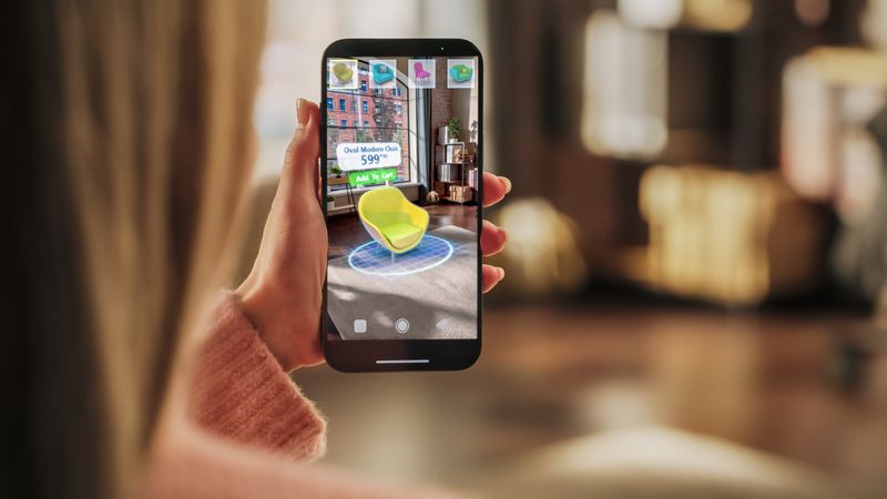 Decorating Apartment: Woman Holding Smartphone, using Augmented Reality Interior Design Software Chooses 3D Furniture for Home.