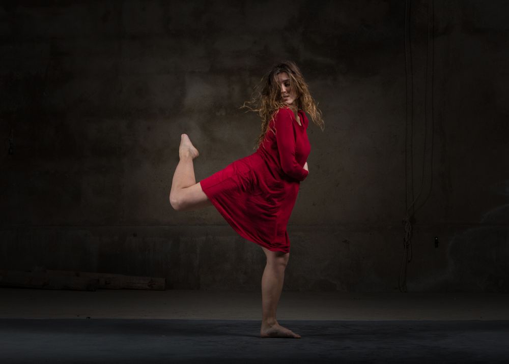 Young woman dancing in darkness