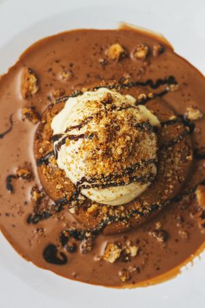 Tasty sweet burger with chocolate crumb and nuts