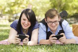 Young Couple at Park Texting Together