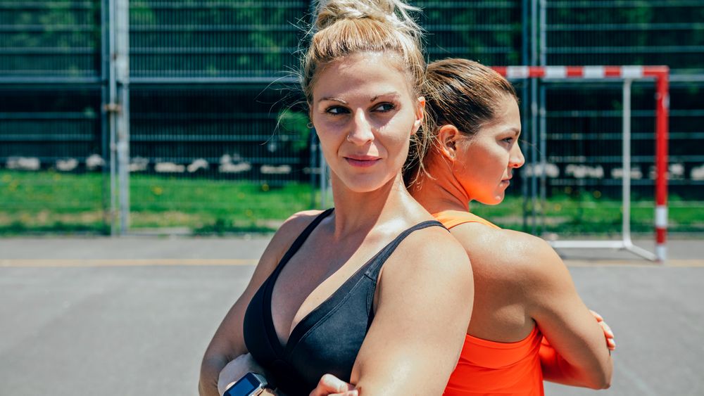 Sportswomen posing with crossed arms