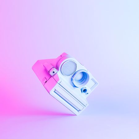 Vintage camera painted in light paint with vibrant bold gradient holographic color lights