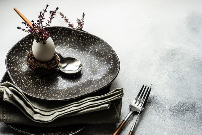 Easter table with heather and egg on dark plate