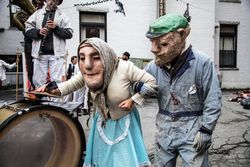 Two performers in puppet masks from the Bread and Puppet Theater, Glover, Vermont