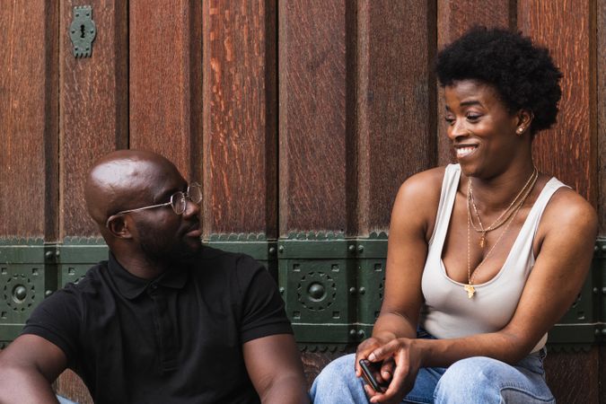 Surprised Black woman sitting with boyfriend