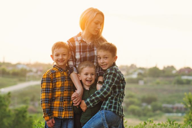 Happy mother and sons at dusk together