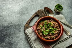 Georgian lobio dish in rustic bowl on kitchen counter