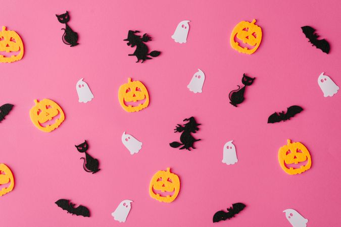 Pattern made of bats, witches, ghosts and jack-o'-lantern on pink background