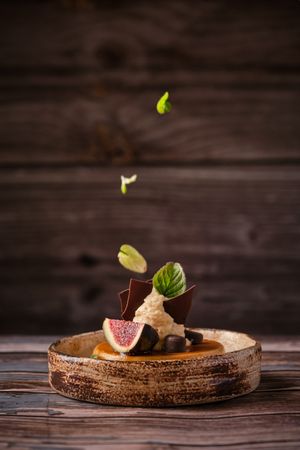Decorating of cheesecake with mint leaves