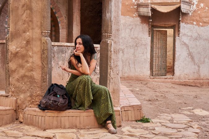 Woman on street between ancient buildings