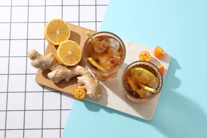 Cold tea with ice, orange slices and mint leaves and ginger
