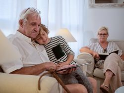 Positive boy with grandfather watching video