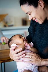 Close up of smiling mother and baby daughter