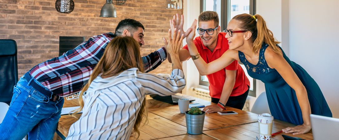 Businesspeople celebrating a success high-fiving