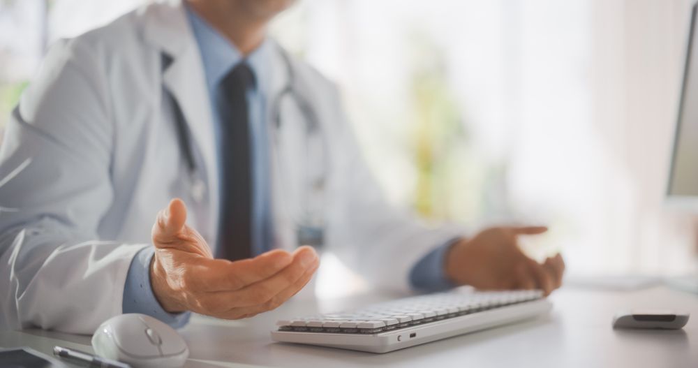 Close Up on Doctor's Hands Explaining Medical Test Results to a Patient During a Health Check Visit