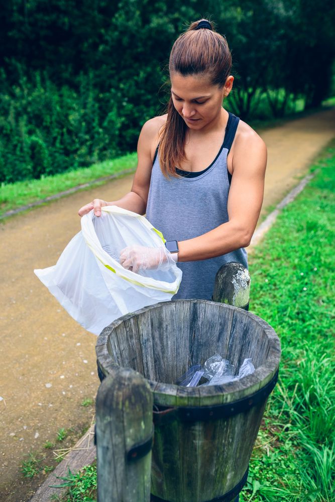 Woman throwing garbage after plogging
