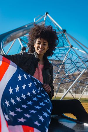 Black woman with afro hair and an american flag.