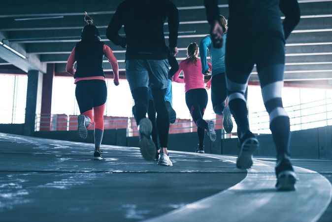 Rear shot of the legs of a group of people running