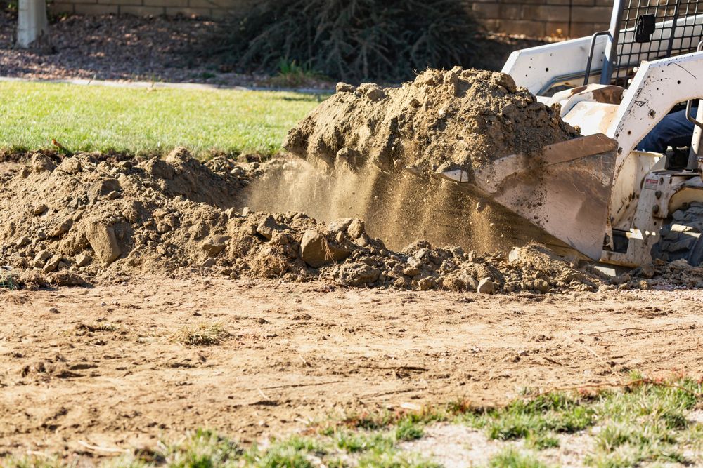Small Bulldozer Digging In Yard For Pool Installation