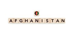 Wooden blocks bearing the name and flag of Afghanistan. Afghan, Arab and Asian Culture, national identity, travel, and geography in a copy space design.