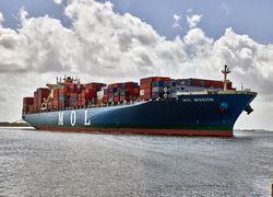 Large container ship on calm water with clouds DbGmY5