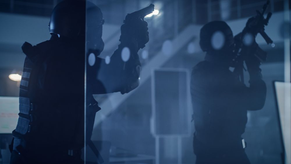 Masked Team of Armed SWAT Police Officers Move in a Hall of a Dark Seized Office Building.