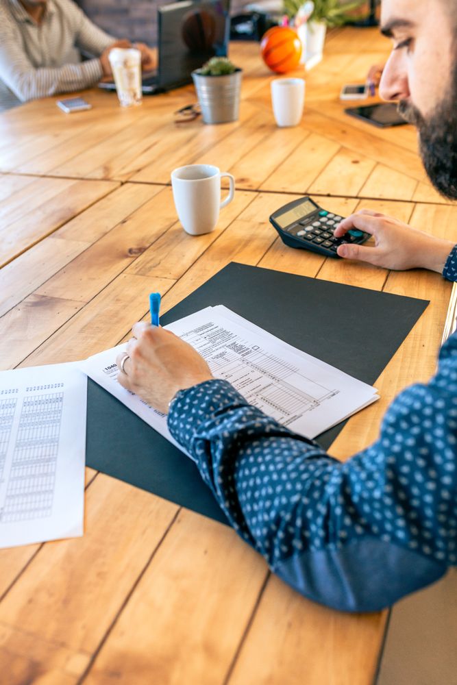 Adviser filling in tax documents in office