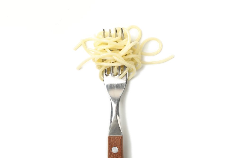Fork with tasty pasta isolated on blank background