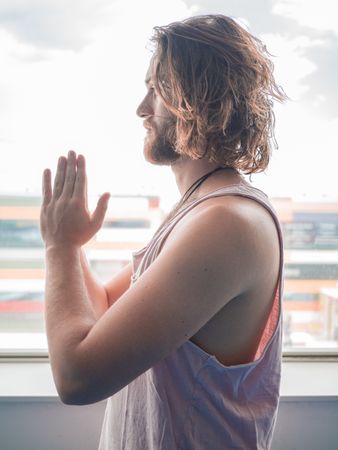 Male doing yoga in spacious room