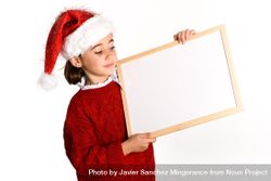 Girl in Santa outfit holding blank board 0PrPe4