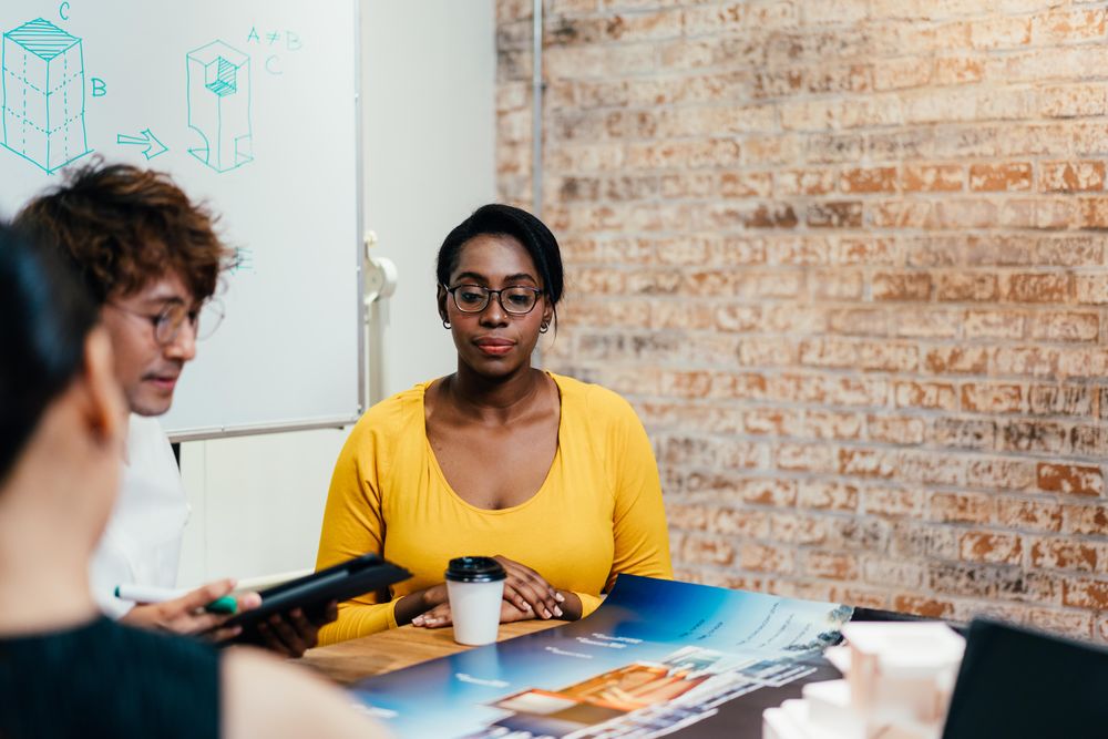 Black woman with colleagues in design firm