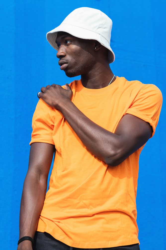 Black man in bright sporty outfit and cap