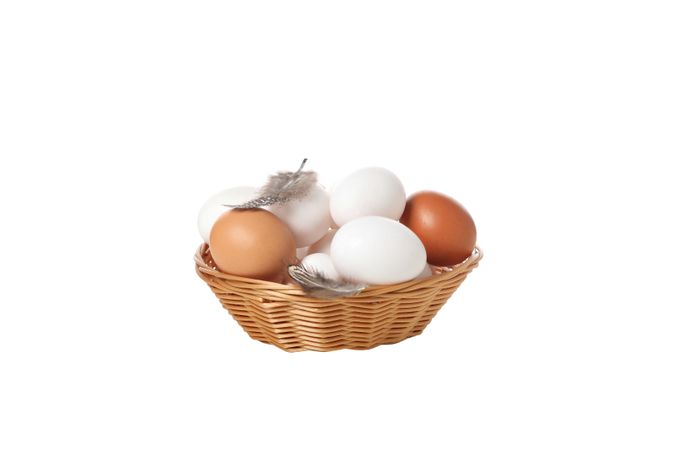 eggs in a round basket, isolated on blank background.
