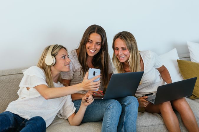 Woman showing video to positive friends