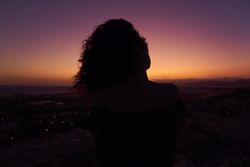 Silhouette of female enjoying picturesque sunset