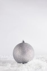 Silver holiday decorations on snow