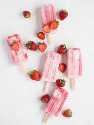 Pink popsicles and fresh strawberries